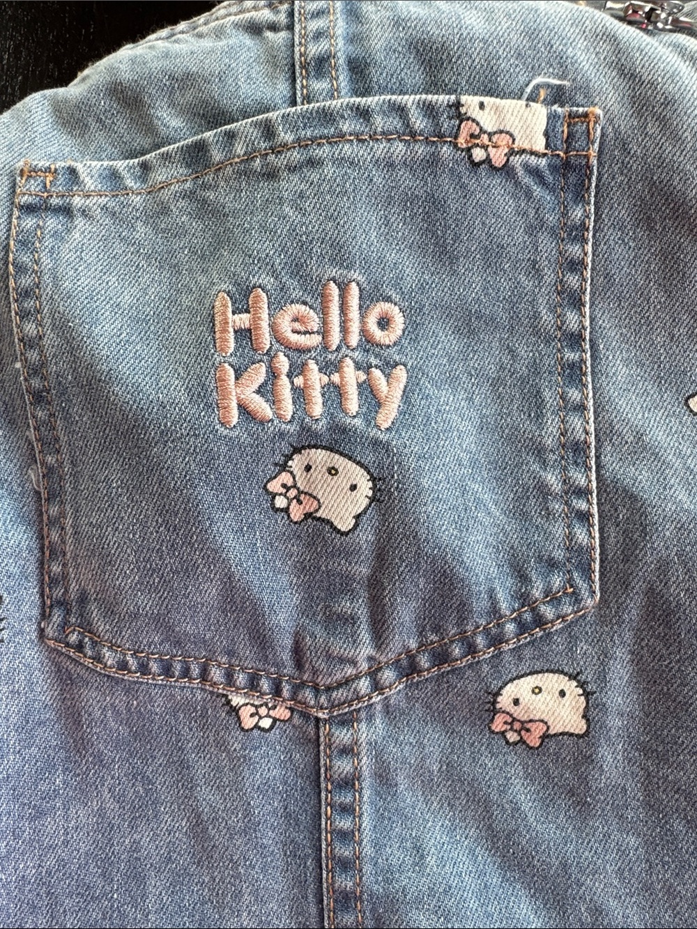 Hello Kitty Light Blue Denim Overall Dress with All-Over Kitty Faces - Picture 3 of 4